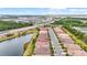 Aerial view of residential community with lush greenery, sidewalks, and beautiful lake views at 11959 Tapestry Ln, Venice, FL 34293
