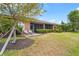 Serene backyard featuring a patio with lounge chairs, lush greenery, and a well-maintained lawn at 11959 Tapestry Ln, Venice, FL 34293