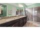 Beautiful bathroom with granite countertops, double sinks, a glass-enclosed shower, and tiled floors at 11959 Tapestry Ln, Venice, FL 34293