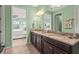 Bathroom features a granite countertop with double sinks and a view into the bedroom at 11959 Tapestry Ln, Venice, FL 34293