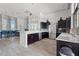 Common area kitchen offers dark wood cabinets, stainless appliances, and marble countertops for luxurious entertaining at 11959 Tapestry Ln, Venice, FL 34293