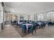 Common area offers ample seating, tables with seating, and luxury vinyl plank flooring at 11959 Tapestry Ln, Venice, FL 34293