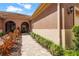 Exterior home view showcasing a paver walkway and well-maintained landscaping at 11959 Tapestry Ln, Venice, FL 34293