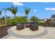 Grill area with seating and lush landscaping overlooking water views in the community at 11959 Tapestry Ln, Venice, FL 34293