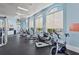 Well-equipped community gym features stationary bikes, televisions, large windows and updated flooring at 11959 Tapestry Ln, Venice, FL 34293