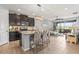 Open-concept kitchen featuring a large island with barstool seating, modern appliances, and tiled flooring at 11959 Tapestry Ln, Venice, FL 34293
