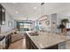 Open concept kitchen featuring granite countertops, stainless steel appliances, and dark wood cabinets at 11959 Tapestry Ln, Venice, FL 34293