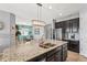 Kitchen featuring granite countertops, stainless steel appliances, and dark wood cabinets at 11959 Tapestry Ln, Venice, FL 34293