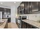 Kitchen featuring granite countertops, stainless steel appliances, and dark wood cabinets at 11959 Tapestry Ln, Venice, FL 34293