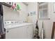 Functional laundry room equipped with a washer, dryer, and storage shelves for supplies at 11959 Tapestry Ln, Venice, FL 34293