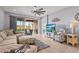 Open concept living room featuring comfortable seating and a view of the screened patio at 11959 Tapestry Ln, Venice, FL 34293