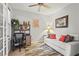 Cozy office space with built-in shelving, a comfortable couch, and natural light at 11959 Tapestry Ln, Venice, FL 34293