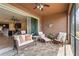 Covered patio with comfortable seating and ceiling fan, ideal for outdoor relaxation at 11959 Tapestry Ln, Venice, FL 34293