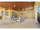 Inviting covered patio with ample seating, ceiling fan, and outdoor television, perfect for entertaining at 11959 Tapestry Ln, Venice, FL 34293