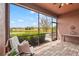Relaxing screened-in porch showcasing beautiful lake views, comfortable seating, and a tranquil outdoor setting at 11959 Tapestry Ln, Venice, FL 34293