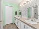 Bathroom with double sinks and a floral wall at 1404 44Th E Ave, Ellenton, FL 34222