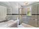 Nicely tiled bathroom featuring a glass-enclosed shower, sleek vanity, and contemporary fixtures at 1417 14Th E St, Bradenton, FL 34208