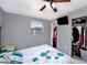 Cozy bedroom features a ceiling fan, closet, and wall-mounted television for comfort and entertainment at 1417 14Th E St, Bradenton, FL 34208