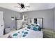 Spacious bedroom with a mirrored headboard, fan, and natural light streaming through the windows at 1417 14Th E St, Bradenton, FL 34208