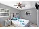 Well-lit bedroom with a ceiling fan, a large bed with floral design and a mirrored headboard at 1417 14Th E St, Bradenton, FL 34208