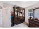 Bedroom featuring a large armoire with glass doors and window views at 1417 14Th E St, Bradenton, FL 34208