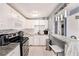 Bright kitchen with white cabinetry, granite countertops, stainless steel appliances and stylish bar seating at 1417 14Th E St, Bradenton, FL 34208