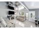 Living room featuring white tile flooring, modern furniture, and a decorative ceiling at 1417 14Th E St, Bradenton, FL 34208