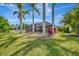 Lush backyard featuring a screened lanai, pool, mature trees, and scenic views at 14315 Tree Swallow Way, Lakewood Ranch, FL 34202
