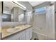 Well-lit bathroom featuring a double vanity, tub with shower, and ample mirror space at 14315 Tree Swallow Way, Lakewood Ranch, FL 34202