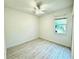 Clean bedroom with light-colored wood flooring, ceiling fan and a bright window at 14315 Tree Swallow Way, Lakewood Ranch, FL 34202