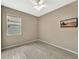 Cozy bedroom with a large window and wood-look flooring; TV included at 14315 Tree Swallow Way, Lakewood Ranch, FL 34202