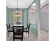 Charming dining area with a modern chandelier, light-colored floors, and view of the front door at 14315 Tree Swallow Way, Lakewood Ranch, FL 34202