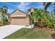 Charming single-Gathering home with a well-maintained lawn, attached garage, and neutral-toned exterior at 14315 Tree Swallow Way, Lakewood Ranch, FL 34202