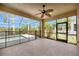 Spacious screened lanai with a ceiling fan overlooking pool and picturesque lake view at 14315 Tree Swallow Way, Lakewood Ranch, FL 34202