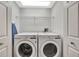 Functional laundry room featuring a side-by-side washer and dryer at 14315 Tree Swallow Way, Lakewood Ranch, FL 34202