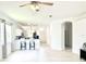 Open living room with a ceiling fan and views of the kitchen and entryway at 14315 Tree Swallow Way, Lakewood Ranch, FL 34202