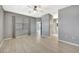 Open living room with light floors, a ceiling fan, and doorways leading to other parts of the house at 14315 Tree Swallow Way, Lakewood Ranch, FL 34202