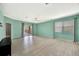 Bright living room with light-colored flooring, neutral walls, and sliding glass doors to a balcony at 14315 Tree Swallow Way, Lakewood Ranch, FL 34202