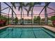 Enclosed pool with views of the lake and palm trees at 14315 Tree Swallow Way, Lakewood Ranch, FL 34202