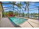 Enclosed pool overlooking a serene lake view, surrounded by lush landscaping at 14315 Tree Swallow Way, Lakewood Ranch, FL 34202