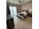 Bedroom featuring a bed, side tables, and a sliding glass door with curtains to a balcony at 1500 State St # 401, Sarasota, FL 34236