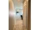 Hallway leading to a living area with a mounted TV, complemented by modern tile flooring at 1500 State St # 401, Sarasota, FL 34236