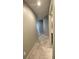 Hallway featuring neutral paint and tile floors, leading to various rooms within the unit at 1500 State St # 401, Sarasota, FL 34236
