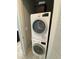 Compact laundry area with stacked Bosch washer and dryer for convenience at 1500 State St # 401, Sarasota, FL 34236