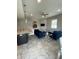 Open living area featuring stylish blue furniture, a modern kitchen, and sleek tiled floors at 1500 State St # 401, Sarasota, FL 34236