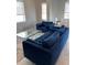 Inviting living room with comfortable blue seating, a glass coffee table, and ample natural light at 1500 State St # 401, Sarasota, FL 34236