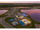 High-angle view showcasing the community clubhouse, recreational area, and community pool near the lake at 17418 Blue Ridge Pl, Lakewood Ranch, FL 34211