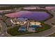 Aerial view of community clubhouse, pool, and recreational courts nestled along a picturesque lake at 17418 Blue Ridge Pl, Lakewood Ranch, FL 34211