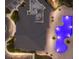 Aerial view of the community pool with lights, community building with gray roof and the parking lot at 17418 Blue Ridge Pl, Lakewood Ranch, FL 34211