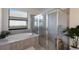 Luxurious bathroom featuring a sleek tub and modern glass shower at 17418 Blue Ridge Pl, Lakewood Ranch, FL 34211